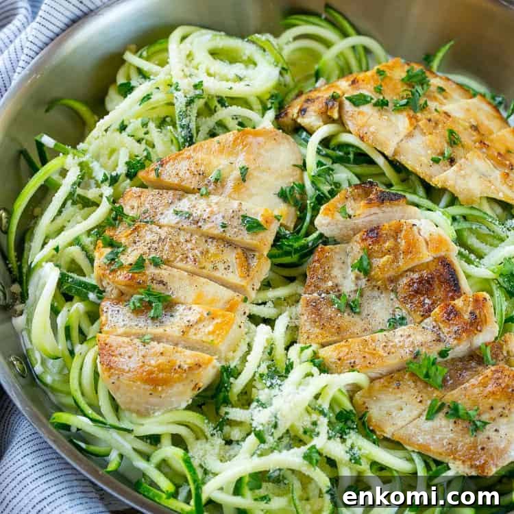 Chicken Alfredo Zoodles in pan with chicken and parsley 