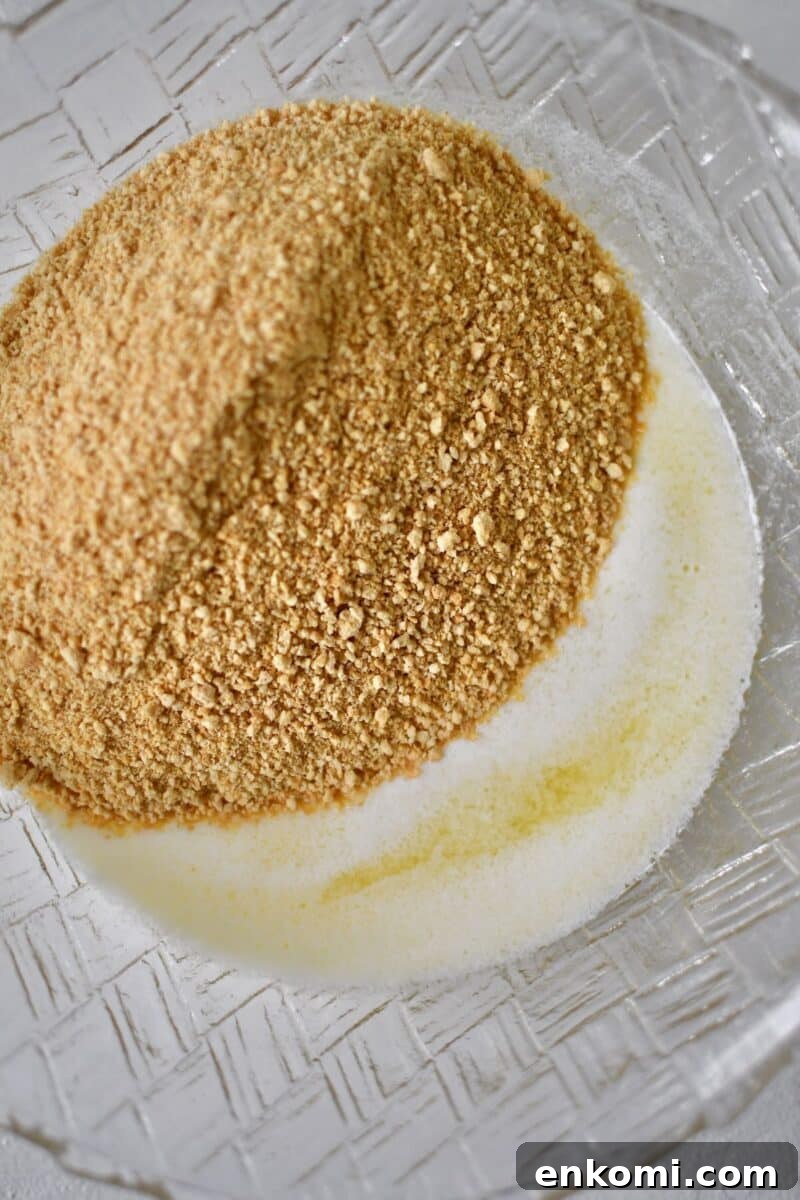 Decadent Banana Split Layer Cake Recipe 4 Melted butter and graham cracker crumbs in a bowl to form the crust.