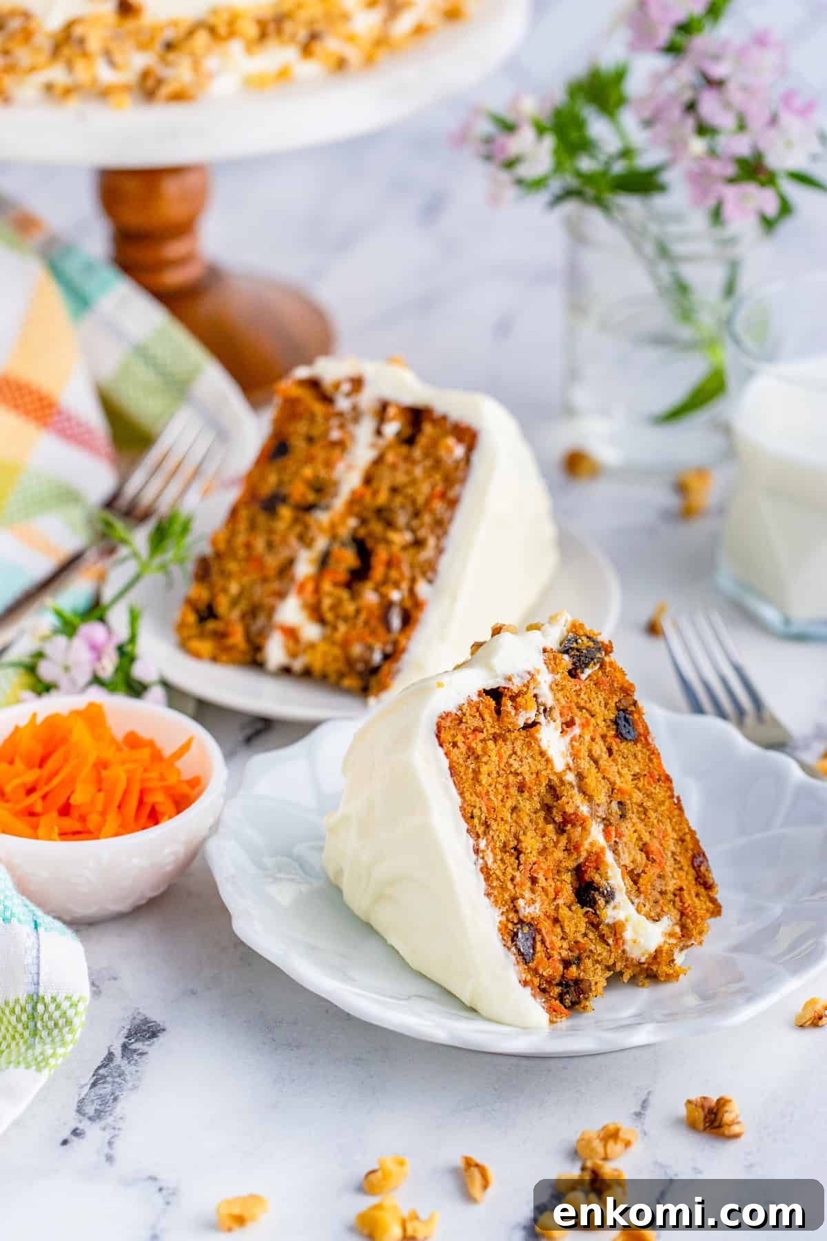 Two slices of Carrot Cake on white plates