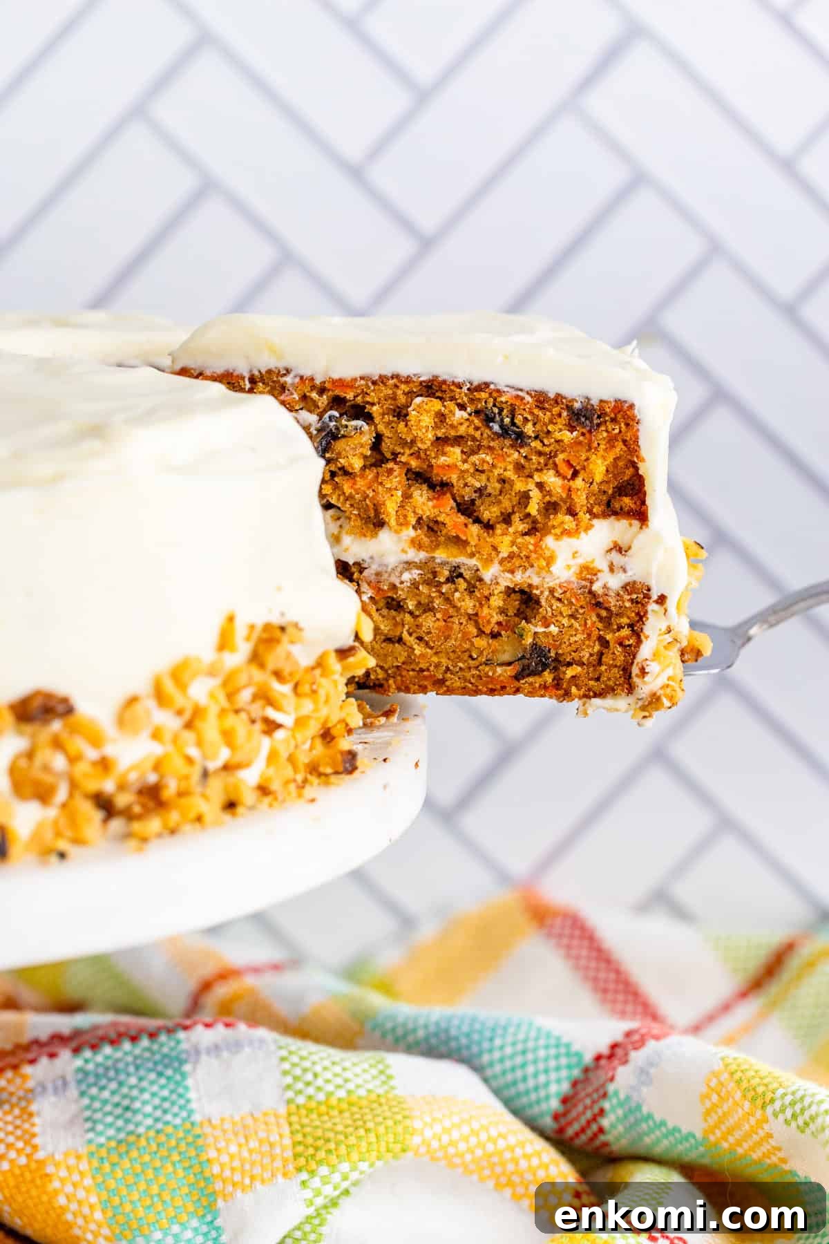 Cake server pulling out slice of Carrot Cake
