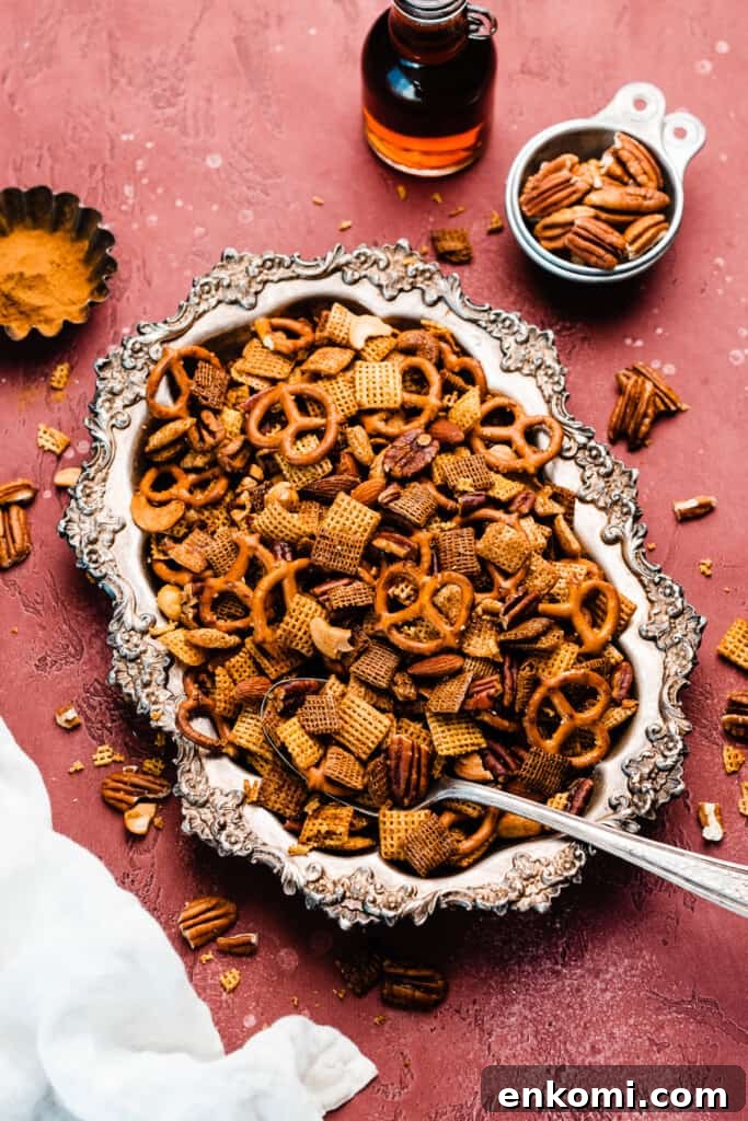 Sweet and Salty Maple Chex Mix Recipe for Snack Lovers 11 A vintage tray of chex mix on a burgundy background.