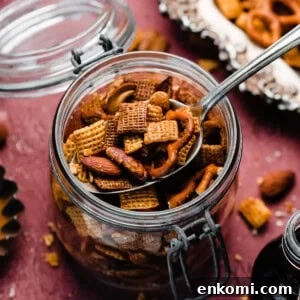 Sweet and Salty Maple Chex Mix Recipe for Snack Lovers 12 A jar of the maple chex on a burgundy backdrop.