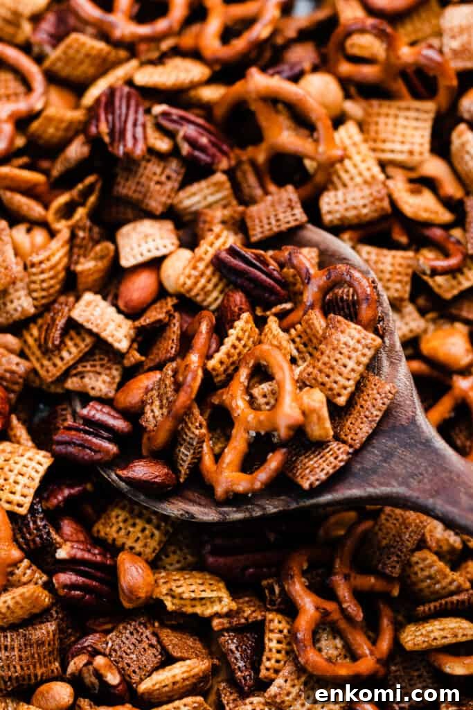 Sweet and Salty Maple Chex Mix Recipe for Snack Lovers 8 A close-up of a serving spoon in the chex mix.