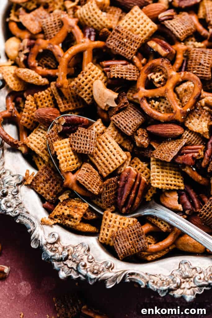 Sweet and Salty Maple Chex Mix Recipe for Snack Lovers 10 A close-up of a serving spoon in the vintage tray of chex mix.