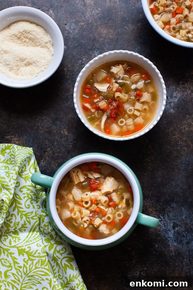 sicilian chicken soup in a couple of different bowls and a green towel
