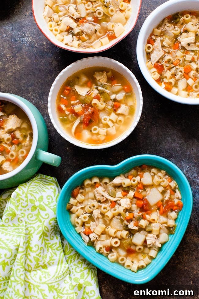 Spicy Chicken Soup in various sized and shaped bowls with a green towel