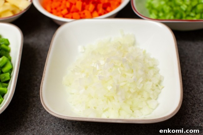 chopped onions and other vegetables in the background