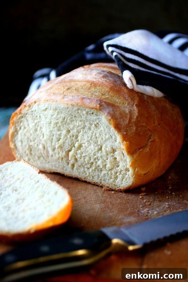 Troubleshooting Yeast Bread: Common Problems and Fixes 2 A baked loaf of rustic bread is baked and sliced on the table.