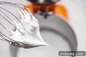How to Make Silky Swiss Meringue Buttercream for Cakes and Cupcakes 4 Whipped Swiss meringue buttercream on a stand mixer whisk.