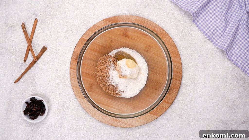 A mixing bowl with butter, brown sugar, and granulated sugar.