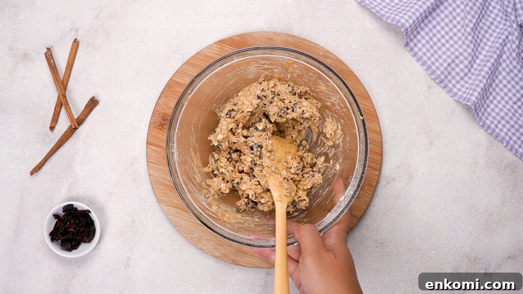 Thick cookie dough being stirred.