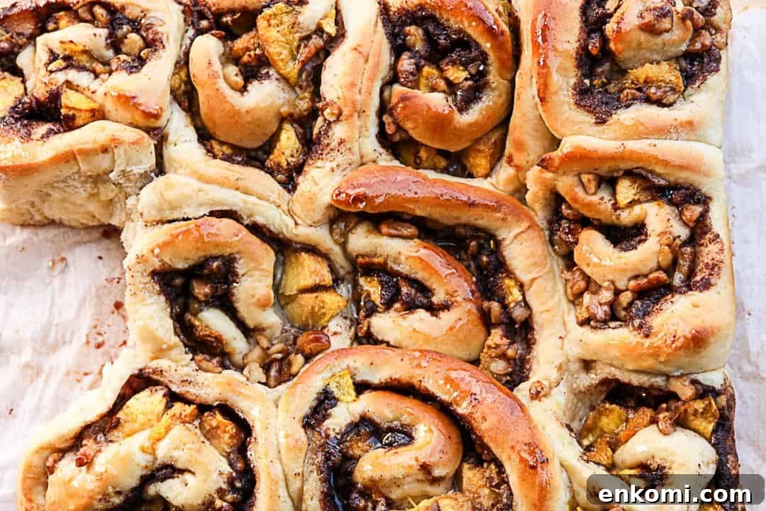 Peach Pecan Cinnamon Rolls with Sticky Glaze 4 A close up of a pan of cinnamon rolls