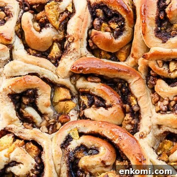 Peach Pecan Cinnamon Rolls with Sticky Glaze 6 A close up of a pan of cinnamon rolls
