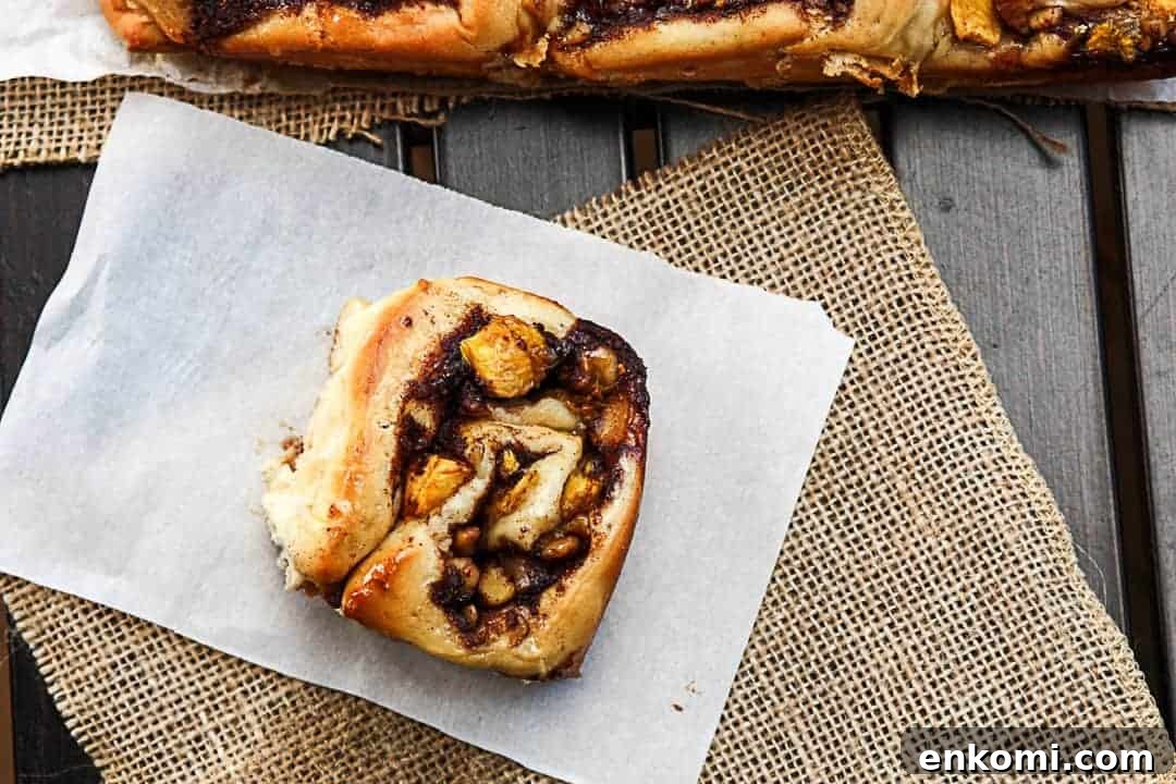 Peach Pecan Cinnamon Rolls with Sticky Glaze 7 A sweet roll sitting on top of a table