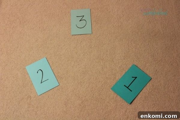 Colored cardstock paper with numbers 1, 2, and 3 written on them and placed apart for a preschooler to jump to, one of the listed fun and easy indoor preschool activities.