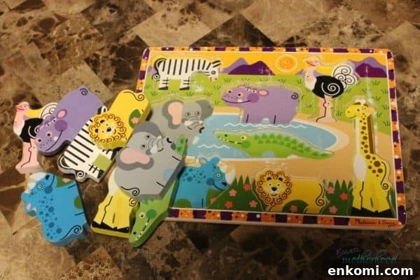 Wood Animal Puzzle on a coffee table with the pieces askew out of the board, right before the pieces are to be hidden for a preschool scavenger hunt.