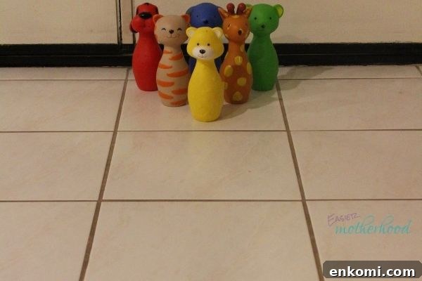 Animal Bowling Pins set up and ready for a toddler to knock down, one of the featured fun and easy indoor preschool activities.
