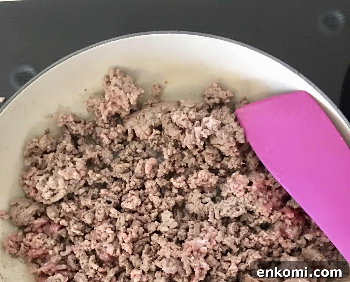 Classic Baked Ziti with Rich Meat Sauce 4 ground beef cooking on stove.
