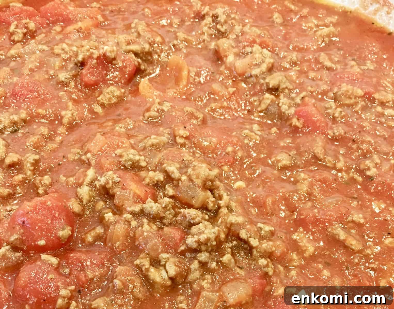 Classic Baked Ziti with Rich Meat Sauce 6 close up of sauce cooking on stovetop.