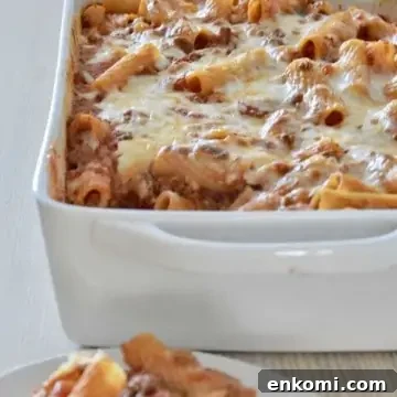 Baked Ziti with meat sauce in a white baking dish.