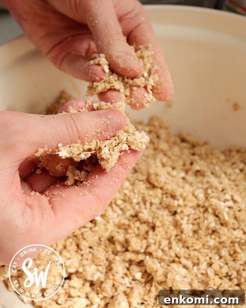hands in a bowl making crumble topping