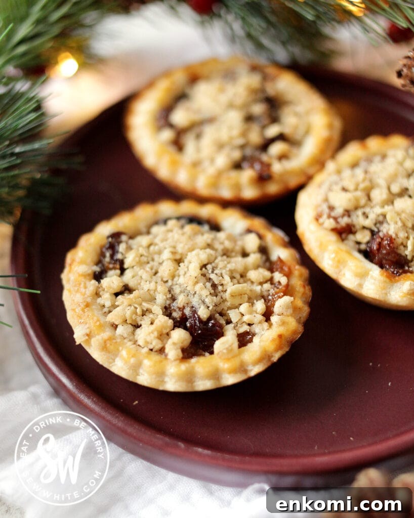crumble topped mince pies on a purple plate