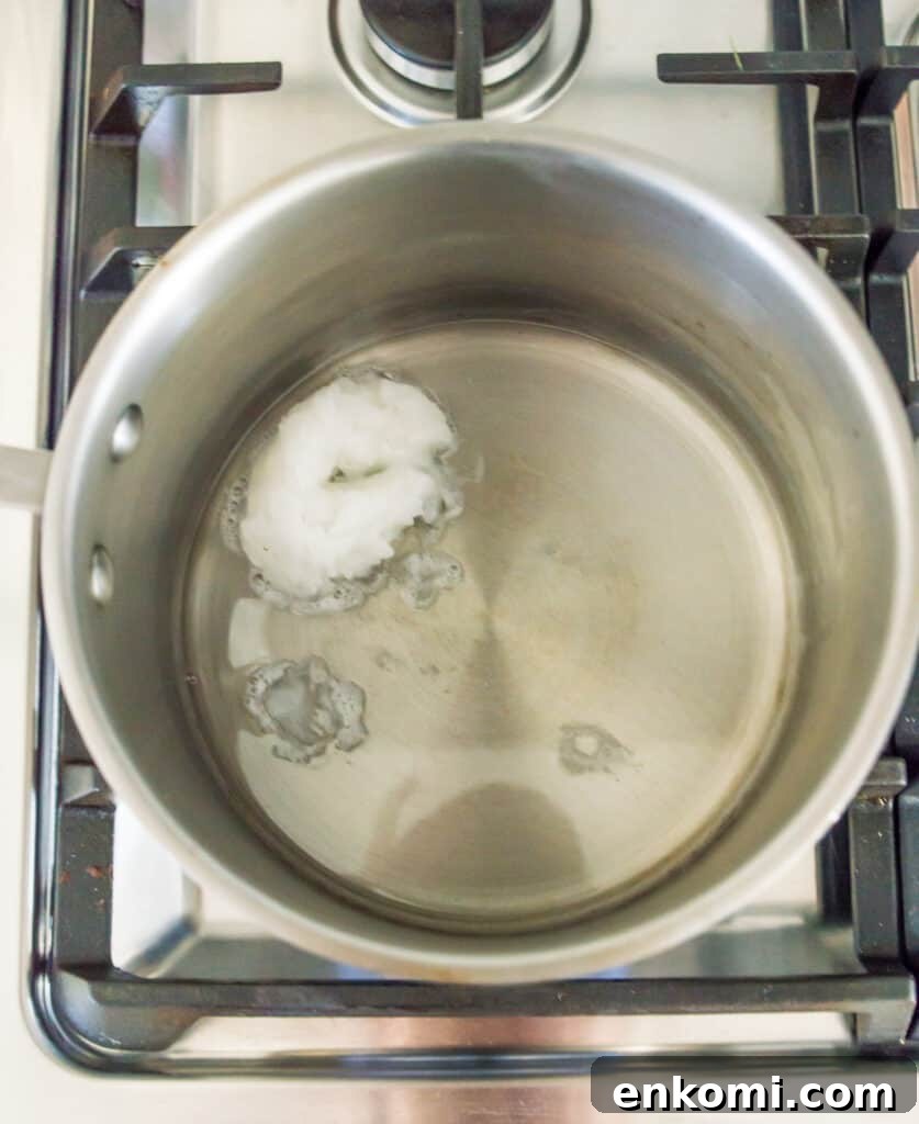 A pot with coconut oil melting in it.