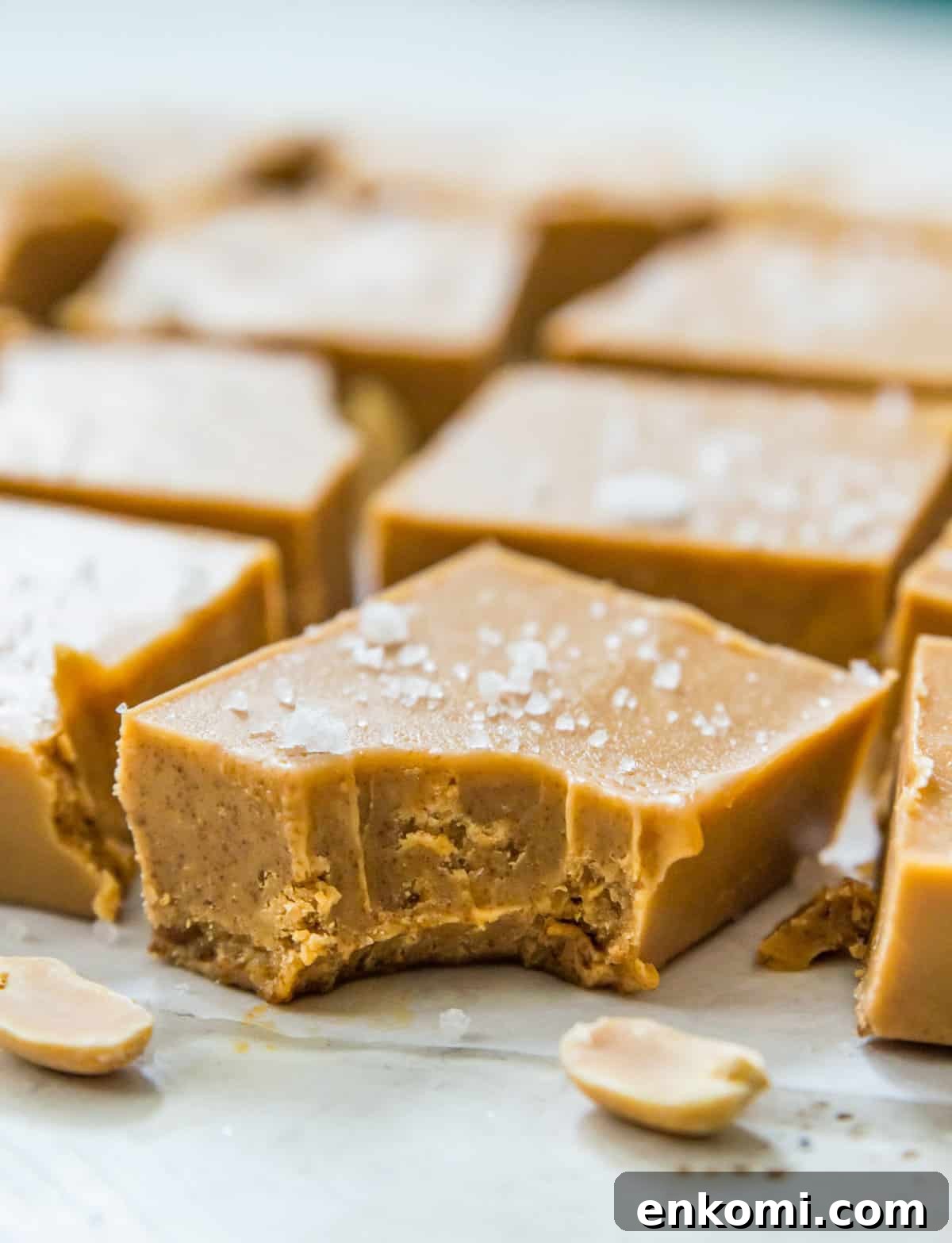 A piece of no bake peanut butter fudge with a bite out of it.