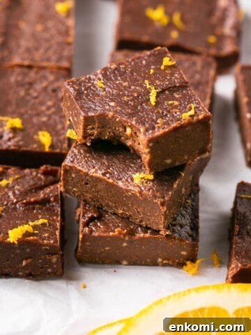 A stack of three pieces of vegan orange chocolate fudge.