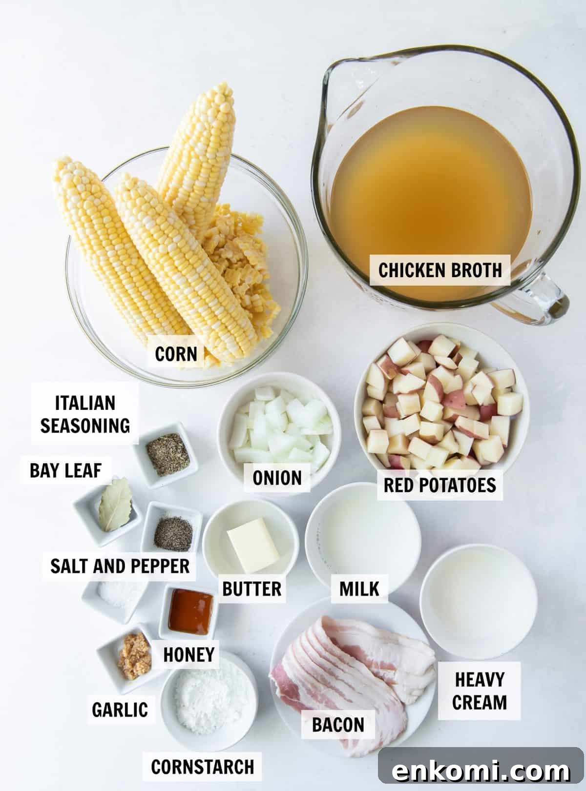 all of the ingredients for corn chowder on a white tabletop