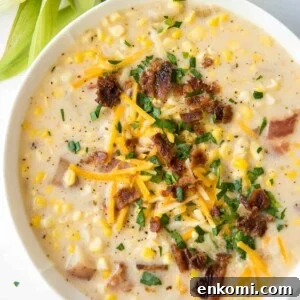 corn chowder in a bowl topped with bacon and cheddar cheese