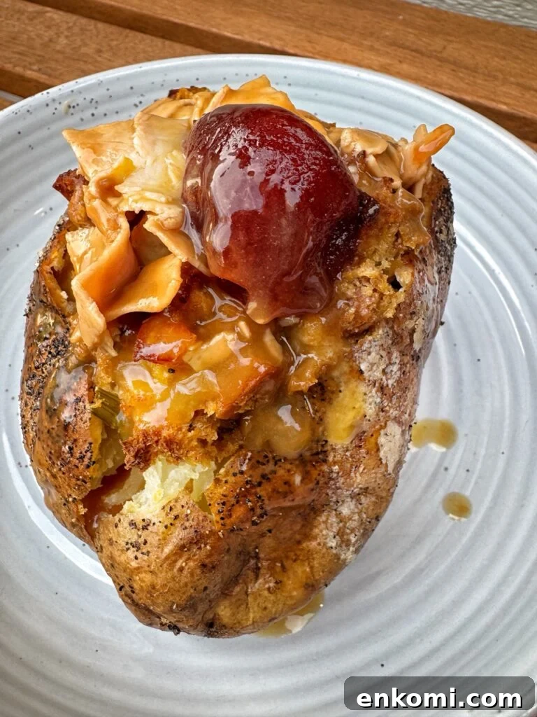 Thanksgiving Stuffed Potatoes Recipe: Flavorful Holiday Side Dish 2 A baked potato stuffed with turkey, gravy, stuffing, and cranberry sauce