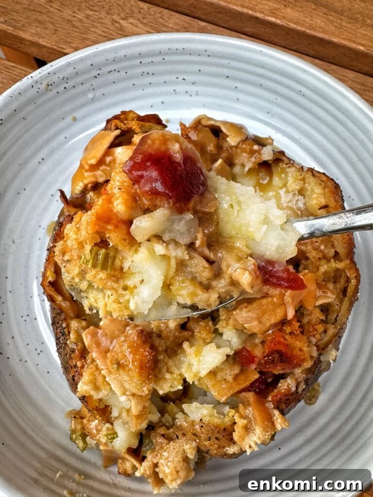 Thanksgiving Stuffed Potatoes Recipe: Flavorful Holiday Side Dish 3 A spoonful of the potato with all the toppings