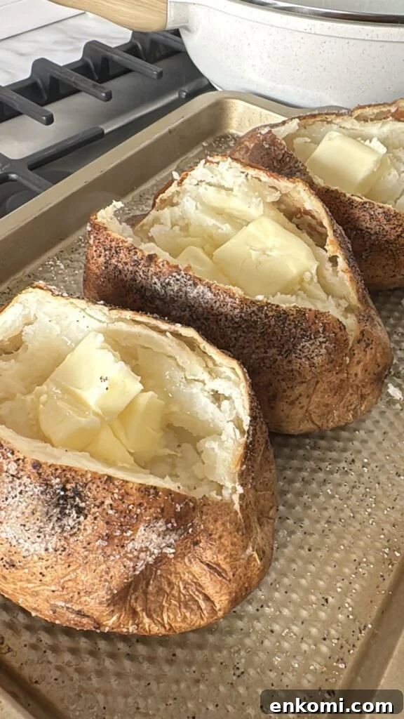Thanksgiving Stuffed Potatoes Recipe: Flavorful Holiday Side Dish 4 Baked potatoes split open with butter pats