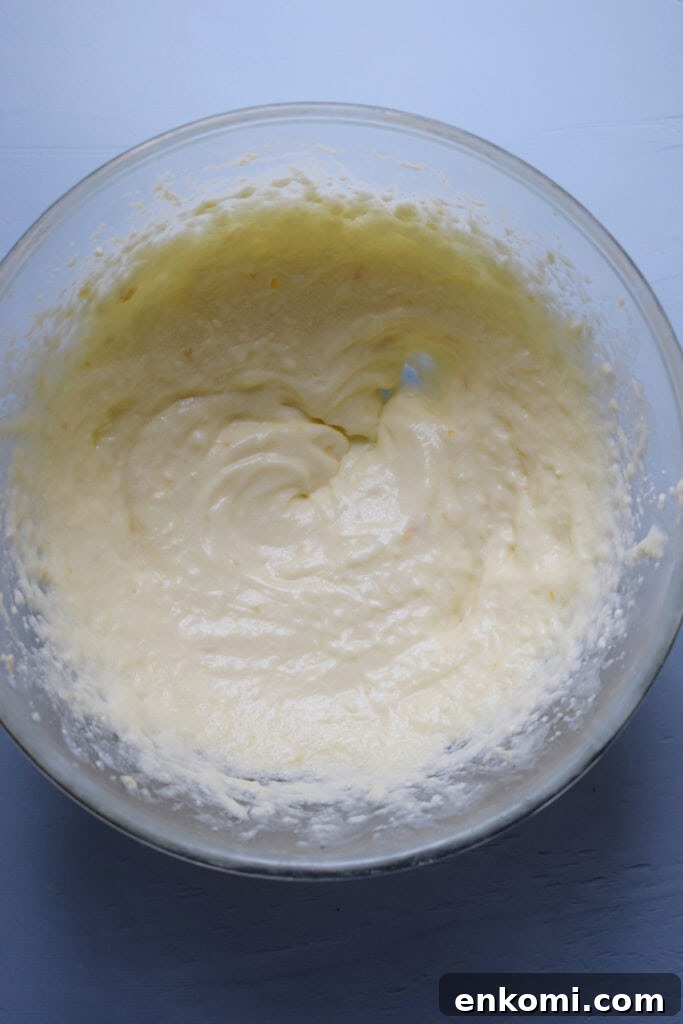 Whipped butter, sugar and ricotta cheese in a bowl.