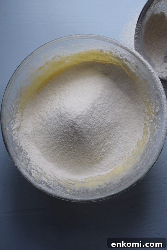 Adding dry ingredients to cookie dough.