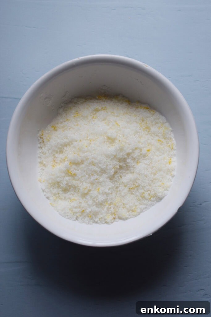 Sugar and lemon zest mixed in a bowl.