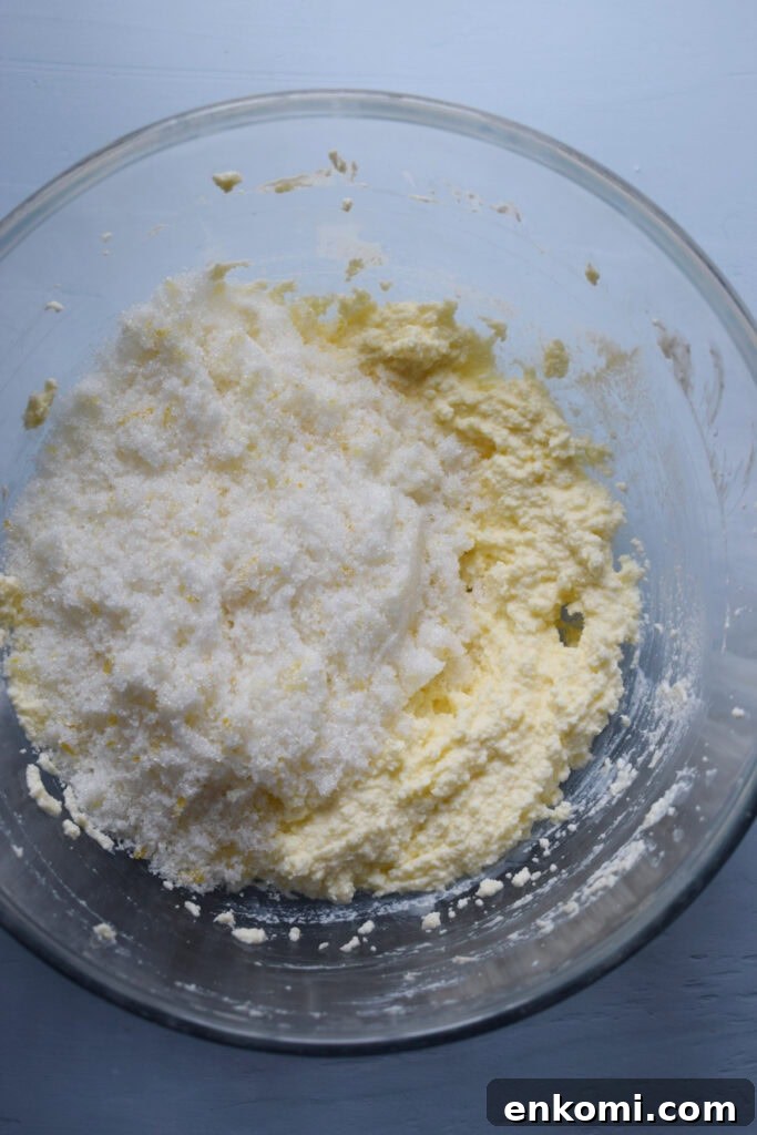 Sugar in a bowl with whipped butter.
