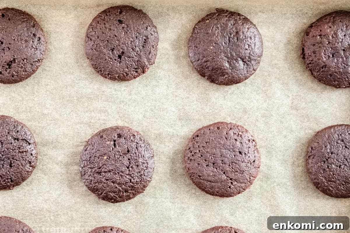close-up overhead view of baked thin mints on a lined baking sheet.