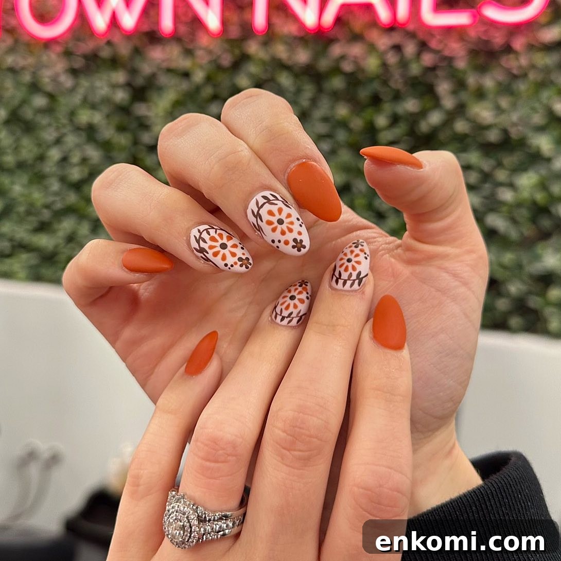 21 Elegant Almond Thanksgiving Nail Designs You’ll Love 20 18. Floral Designs on Orange Nails
