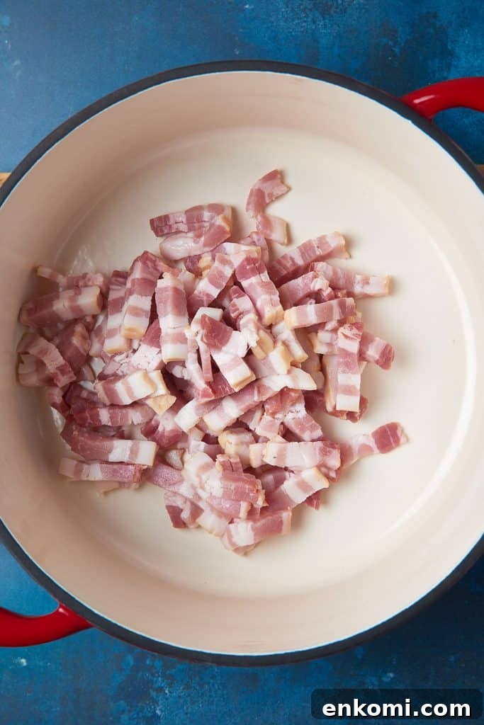 Raw bacon pieces in a soup pot.