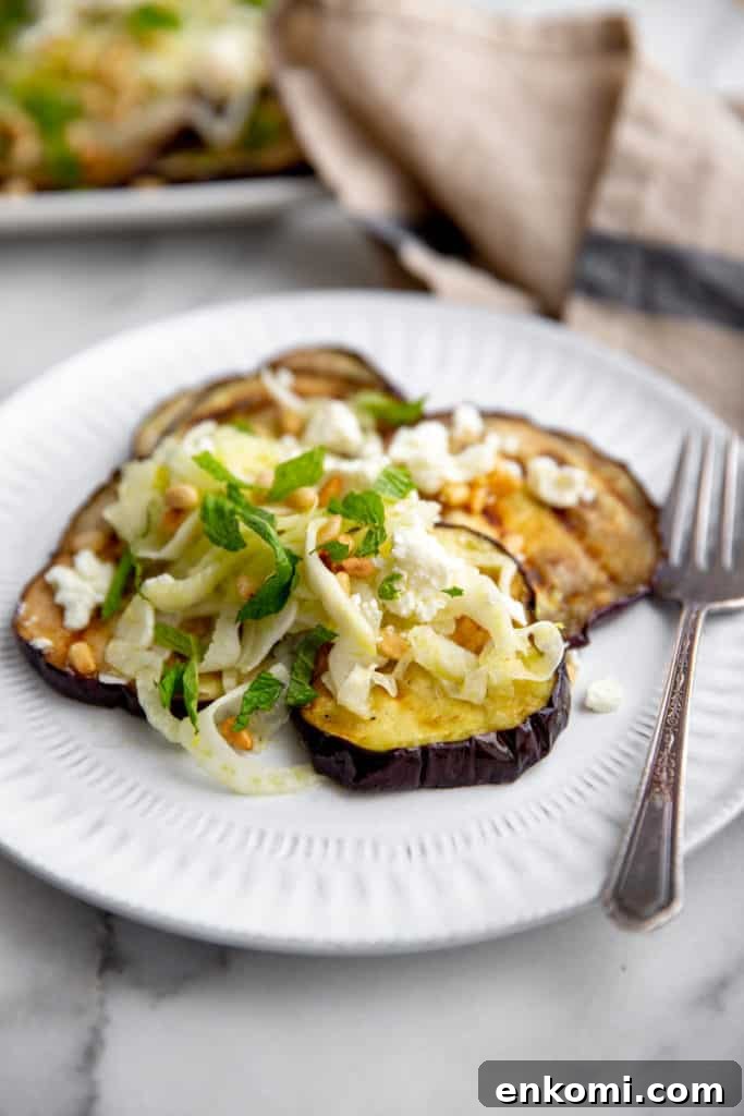 Greek-Style Grilled Eggplant Salad with Simple Grilling Tips 2 Grilled eggplant salad on a plate with a fork alongside.