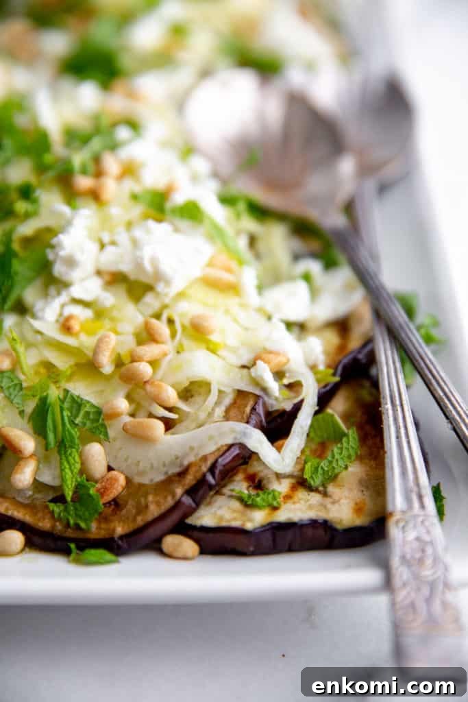 Greek-Style Grilled Eggplant Salad with Simple Grilling Tips 12 Eggplant salad on a serving platter with serving spoons.