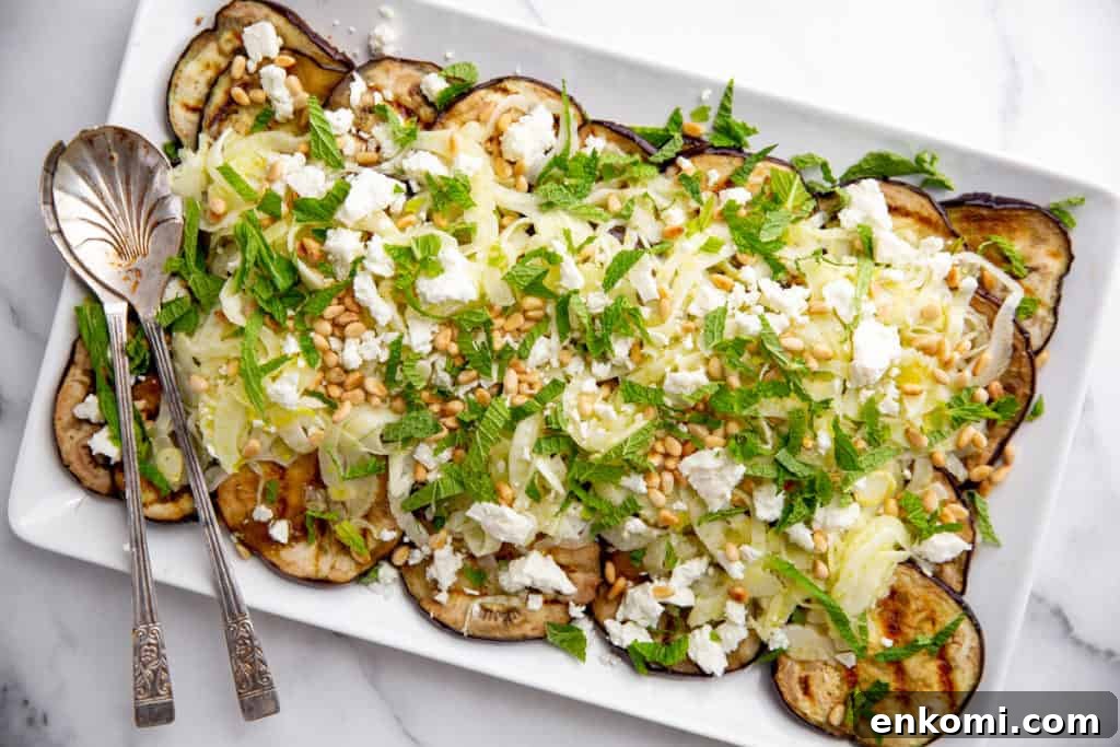 Greek-Style Grilled Eggplant Salad with Simple Grilling Tips 8 Grilled eggplant on a platter topped with fennel, feta, pine nuts and mint.