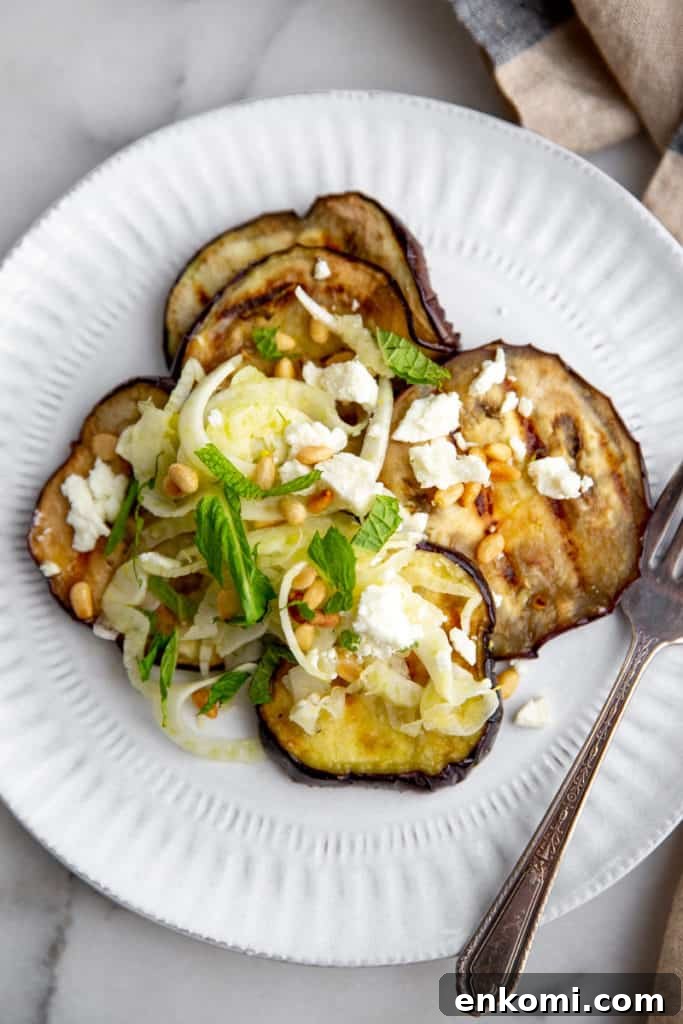 Greek-Style Grilled Eggplant Salad with Simple Grilling Tips 9 Eggplant salad on a plate with a fork alongside.