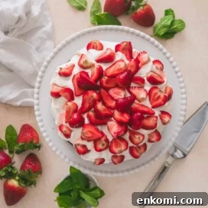 Strawberry and Cream Chocolate Layer Cake Recipe 6 Strawberries and cream chocolate cake on a cake stand with a cake cutter