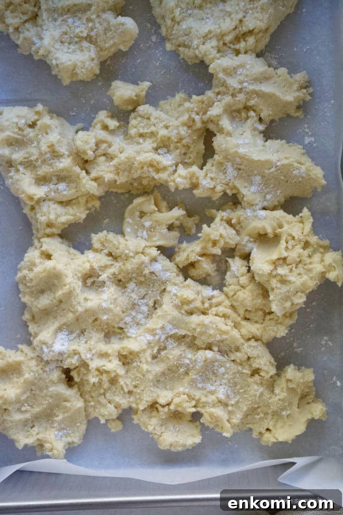 shortbread crust dough in a parchment lined baking pan