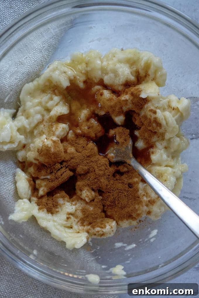 mashed bananas with cinnamon, rum and banana liquor in a mixing bowl