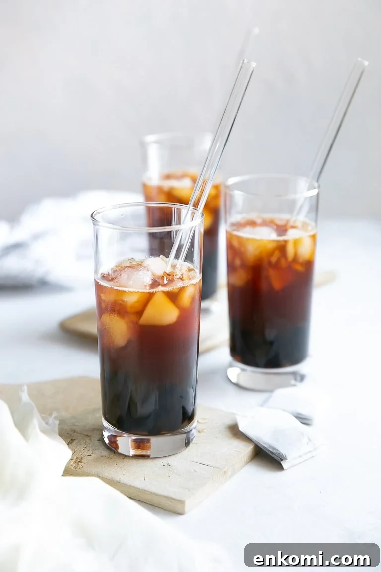 How to Make Authentic Bubble Tea at Home: Tapioca Pearl Recipe 7 Three clear glasses filled with black tea, boba, and ice.