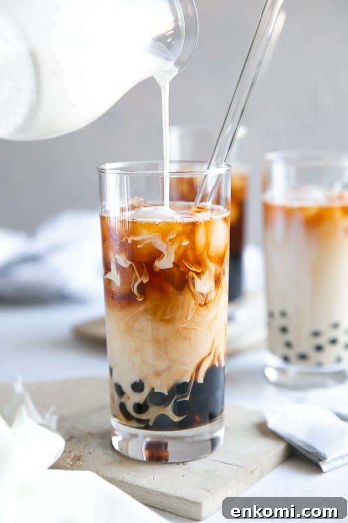 How to Make Authentic Bubble Tea at Home: Tapioca Pearl Recipe 10 A glass of Bubble Tea being poured